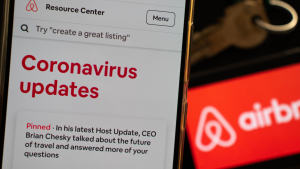 An Airbnb (ABNB) host is checking last updates on Airbnb app regarding covid-19 coronavirus and its impact on tourism and hospitality policies.
