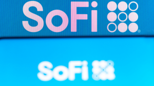 The Social Finance (SoFi) logo is seen on a smartphone and a pc screen