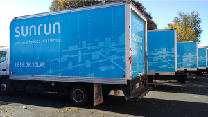 Side-view of Sunrun (RUN) company trucks in their warehouse