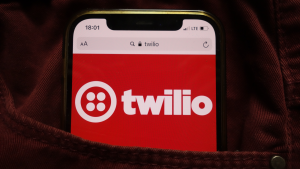 Twilio Inc (TWLO stock) logo displayed on mobile phone hidden in jeans pocket