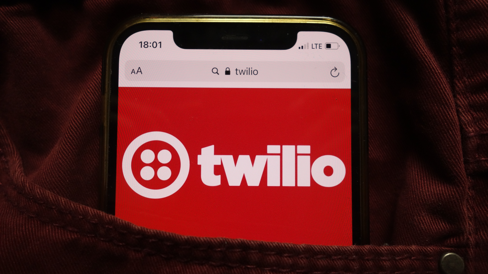 Twilio Inc (TWLO) logo displayed on mobile phone hidden in jeans pocket