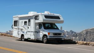 A Winnebago (WGO) recreational vehicle on a road.