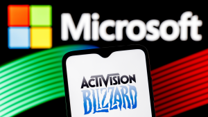 The logo for Activision Blizzard (ATVI) is shown on a phone screen in front of the Microsoft (MSFT) logo.