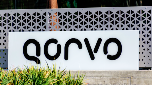 The logo for Qorvo (QRVO) is shown on a sign outside the company's headquarters.