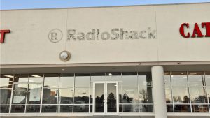 An empty retail location shows the remains of having formerly been a RadioShack.