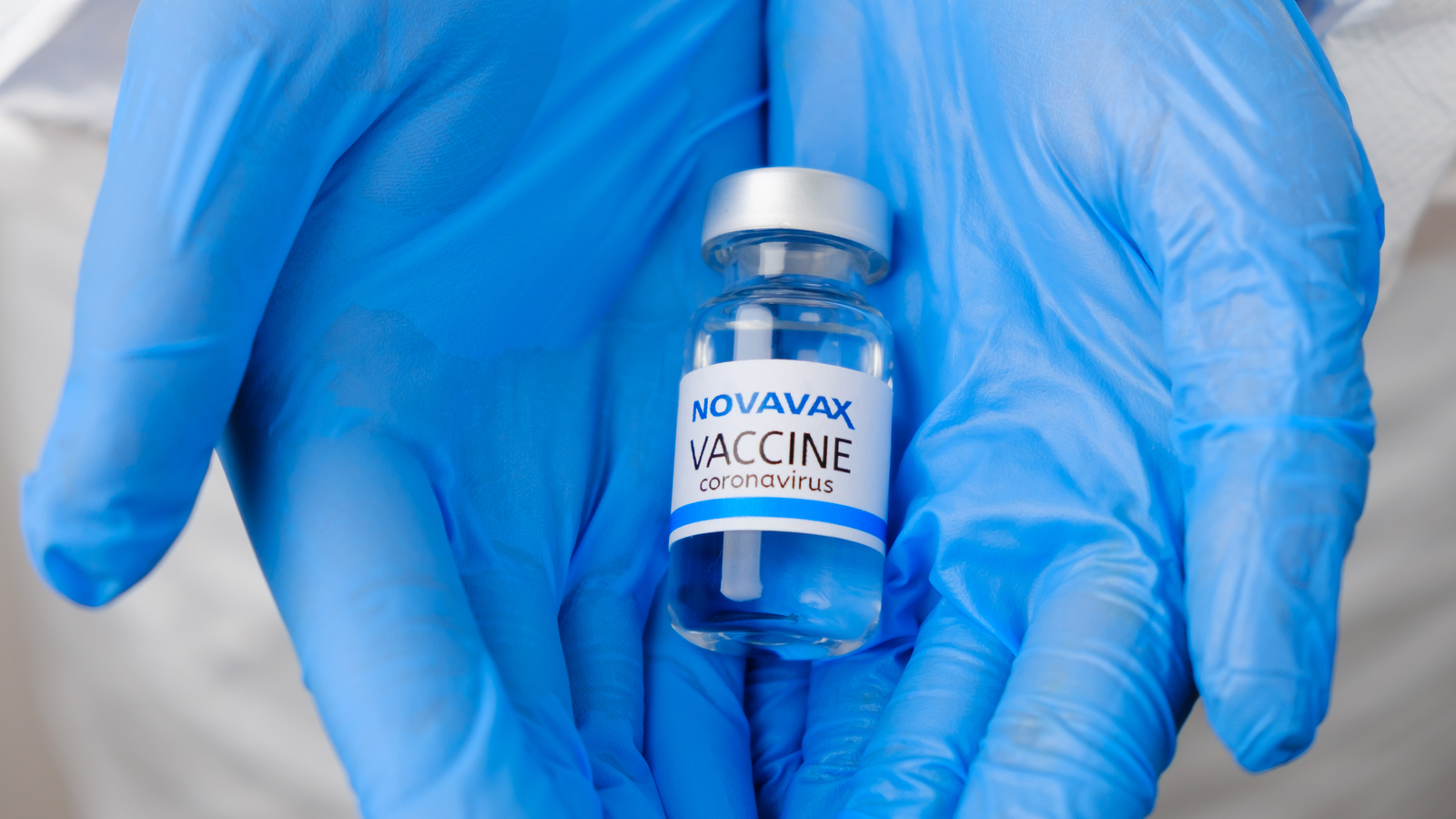 Novavax (NVAX) vaccine for prevention of coronavirus, Covid-19, Sars-Cov-2 in doctors hands in rubber blue gloves