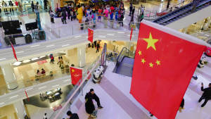 A large shopping mall in the central city is festooned with Chinese flags in celebration of the National Day after the victory against the Covid-19 epidemic representing Chinese Stocks.