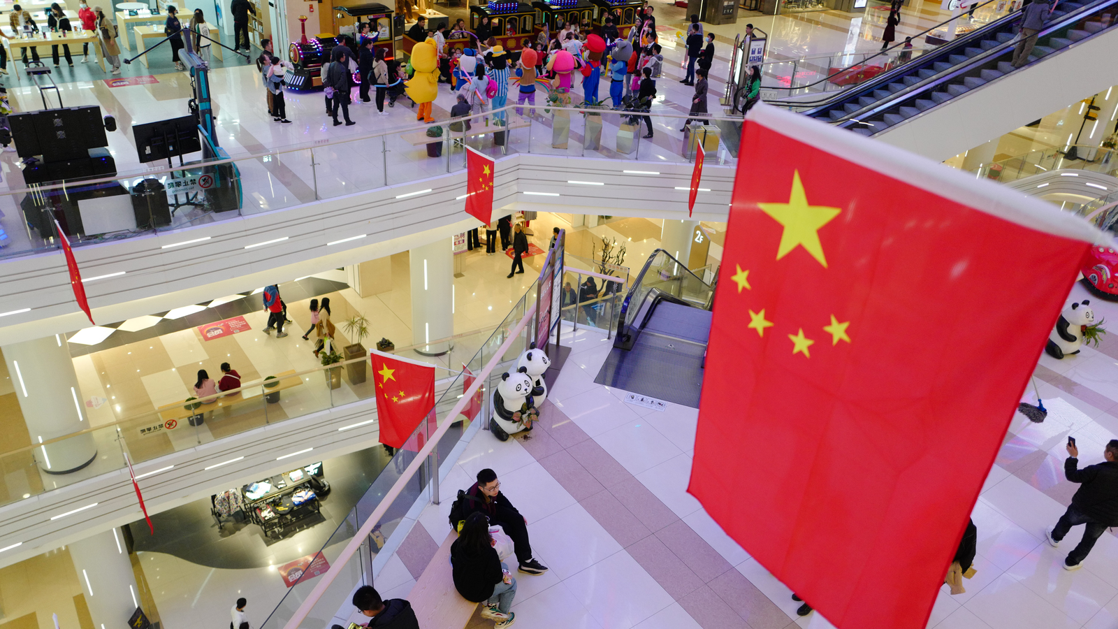 A large shopping mall in the central city is festooned with Chinese flags in celebration of the National Day after the victory against the Covid-19 epidemic.