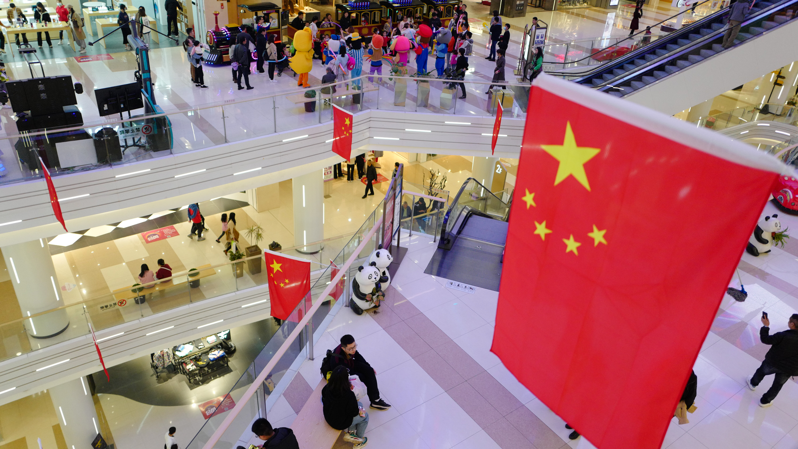 Chinese Stocks. A large shopping mall in the central city is festooned with Chinese flags in celebration of the National Day after the victory against the Covid-19 epidemic.