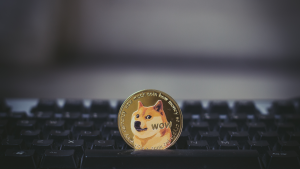 1 golden dogecoin coin on keyboard, meme coins for sale