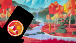 The logo of the cryptocurrency "Decentraland" (MANA) on the display of a smartphone (focus on the logo)