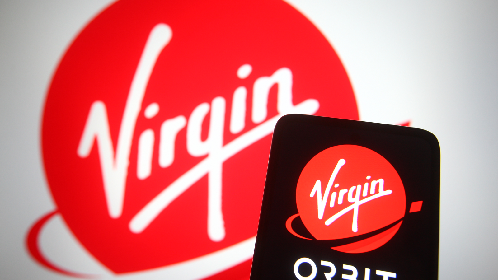 Virgin Orbit (VORB) logo on a smart phone and in background