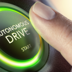 An image of a finger pressing an autonomous drive button; autonomous vehicles