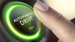 An image of a finger pressing an autonomous drive button