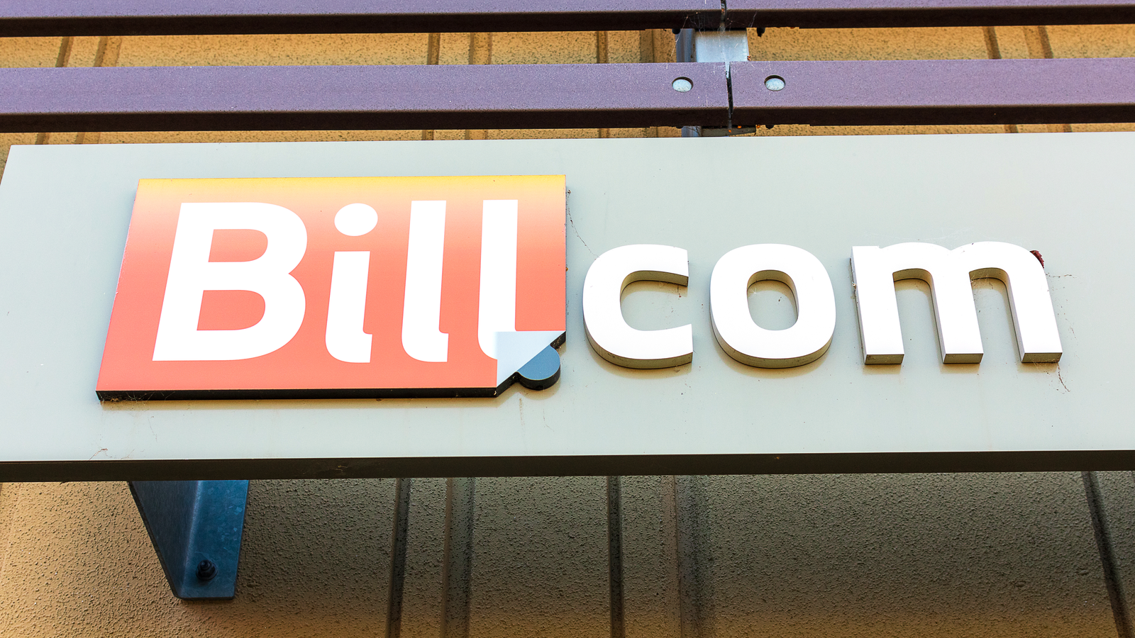The Bill.com logo in front of a building representing BILL stock.