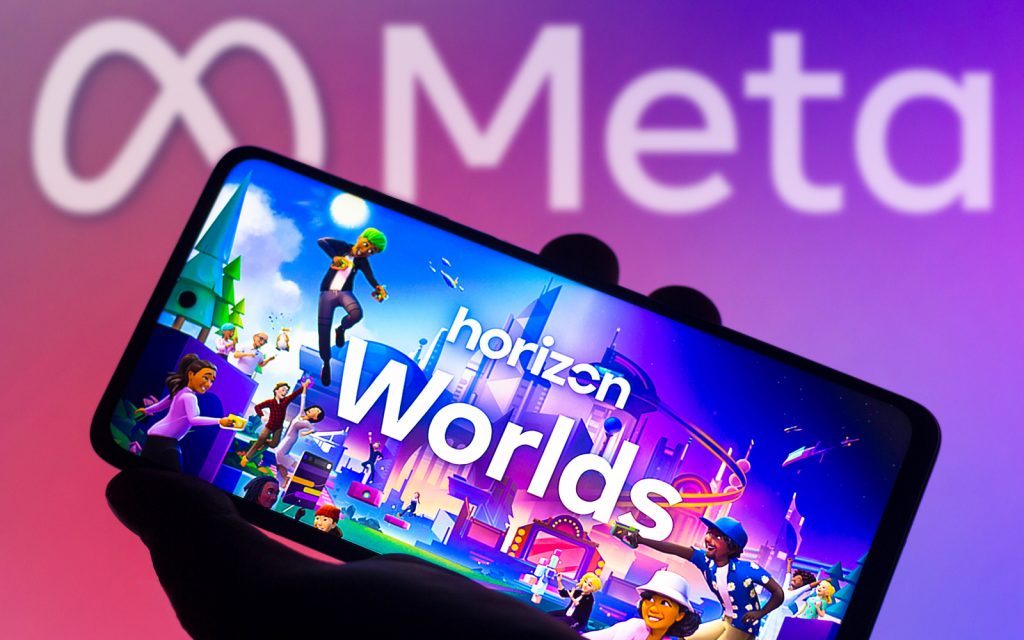 A photo of a phone on the Horizon Worlds screen and the Meta sign behid it