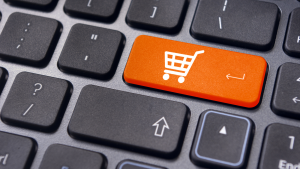 An image of a computer keyboard with a shopping cart button representing SHOP stock.