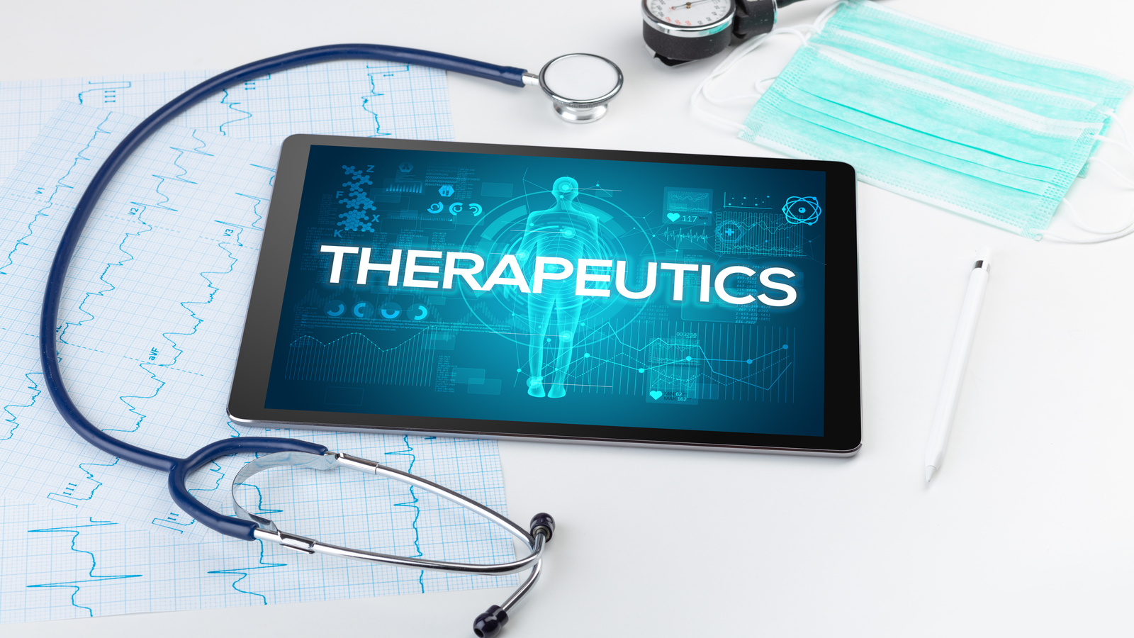 An image of a tablet with 'therapeutics' on the screen, a stethoscope and face mask around it