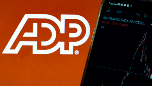 In this photo illustration the stock market information of Automatic Data Processing, Inc. displays on a smartphone with the logo of Automatic Data Processing, Inc. ADP stock.