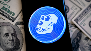 A smartphone with the Apecoin logo on top of money representing price predictions.