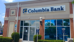 The Columbia Bank logo, owned by Columbia Financial, is seen on the side of a branch.