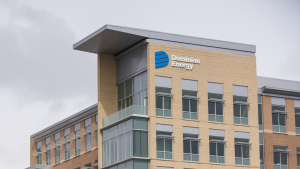 The logo for Dominion Energy (D) is seen at the top of an office building.