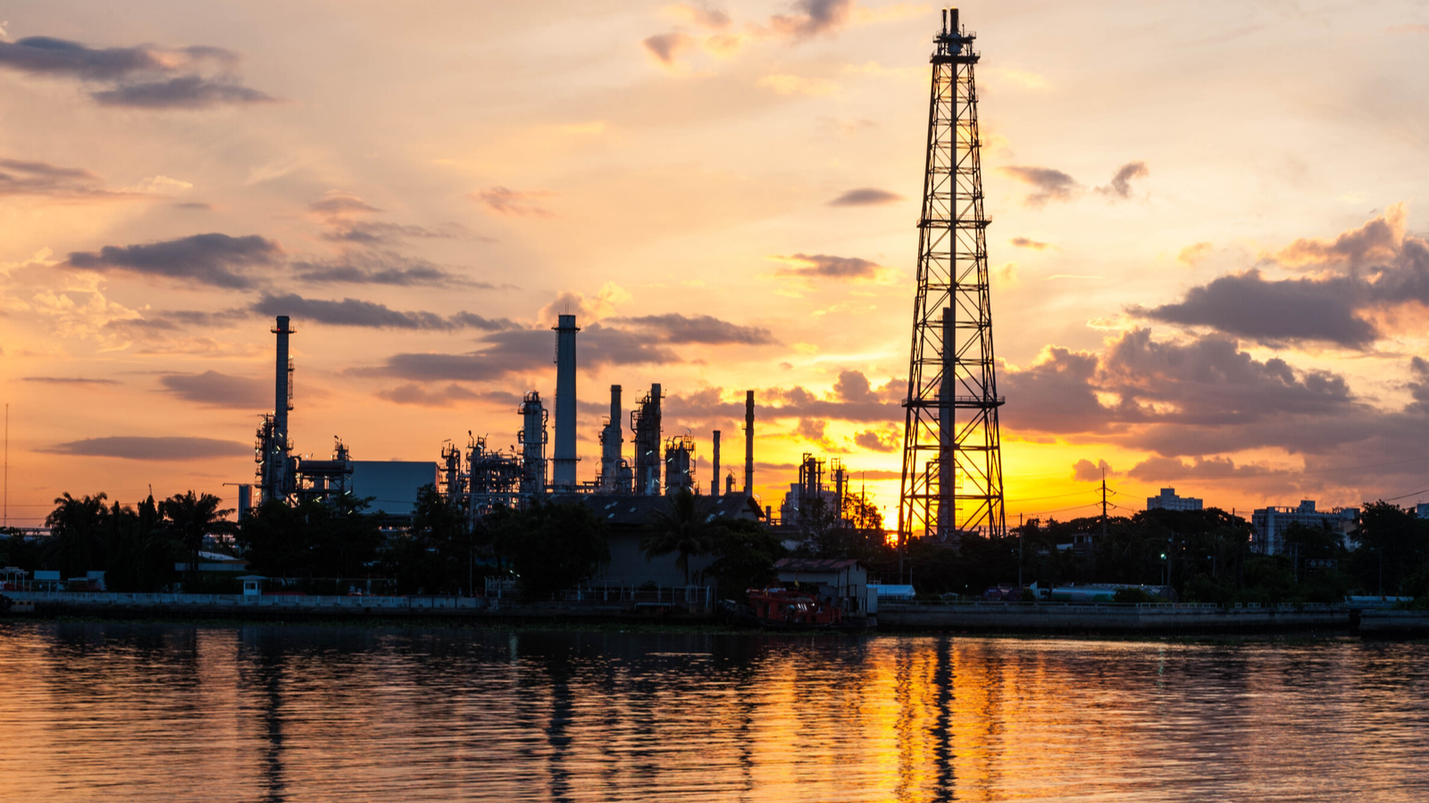 petrochemical plant in night time with reflection over the river, Indonesia.