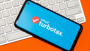 Intuit and turbotax logo on a phone screen on top of a keyboard. INTU stock.