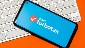 Intuit and turbotax logo on a phone screen on top of a keyboard.  INTU stock.