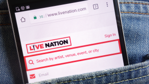 Live Nation website displayed on smartphone hidden in jeans pocket. LYV stock.