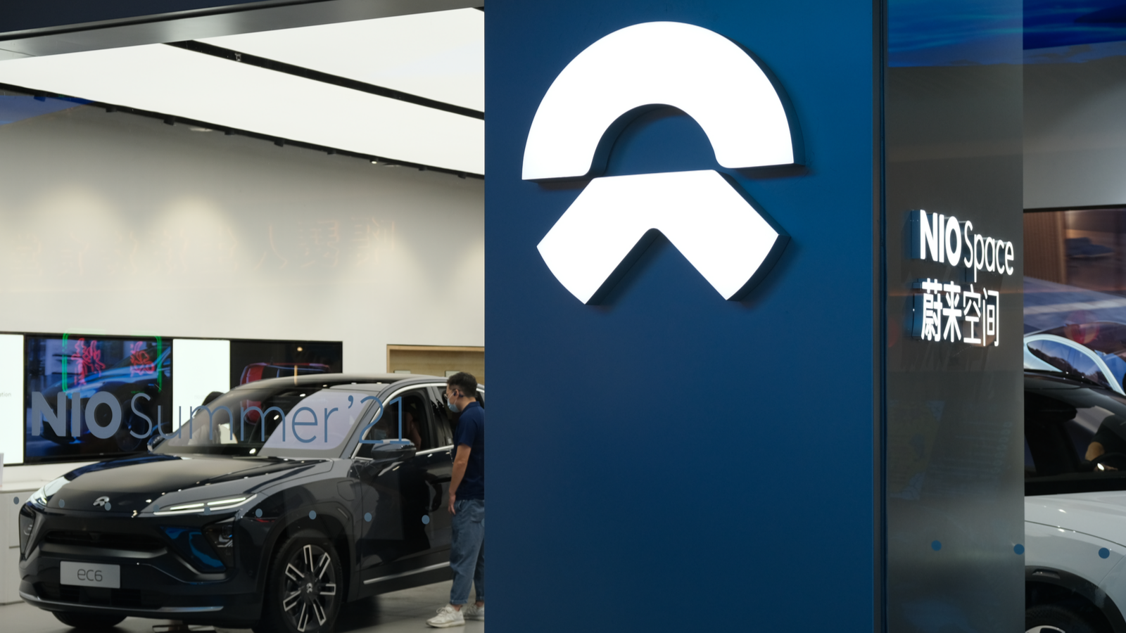 NIO store sign and customer in electric car store. NIO is a Chinese EV company