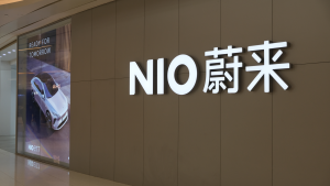 A large NIO store sign and Chinese brand name. NIO is a Chinese EV company. Is NIO Stock a Buy