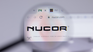 Close up of Nucor logo on website page.  NUDE stock.
