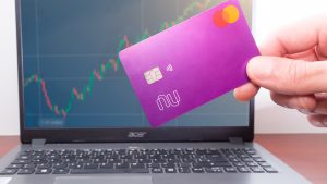 NU stock Nubank Card in front of laptop with stock panel