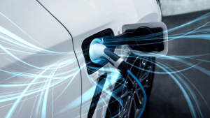 An image of an EV plugged in and charging, with blue light wisps flowing outward from the plug. EV stocks.