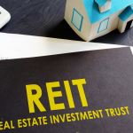 REITs to buy Real estate investment trust REIT on an office desk.