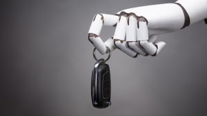 An image of a robotic hand holding a car key, autonomous driving