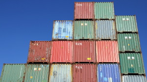 Plenty of shipping containers stacked at the Port of Hamburg and blue sky