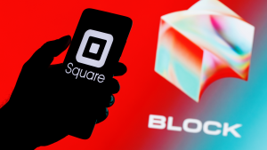 Square, Inc. changes name to Block (SQ stock). Smartphone with Square logo on screen in hand on background of Block logo.