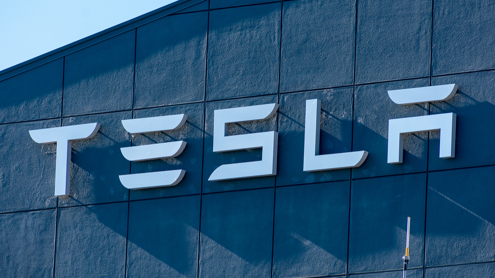 The Tesla (TSLA Stock) logo on the side of a building.