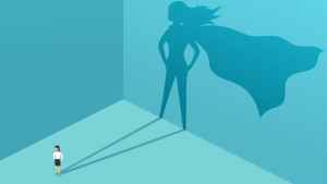 Illustration of business woman casting huge shadow of superhero on a blue wall