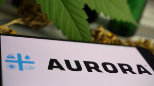 Closeup of mobile phone screen with logo lettering of cannabinoid company Aurora Cannabis (ACB, blurred marijuana leaf (focus on left part of letter R in center) Marijuana Stocks to Sell
