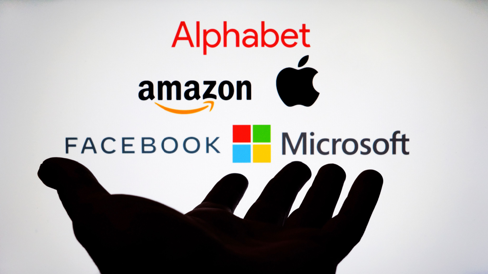 An image of the Big Tech logos above the shadow of a hand; Alphabet, Amazon, Apple, Facebook, Microsoft