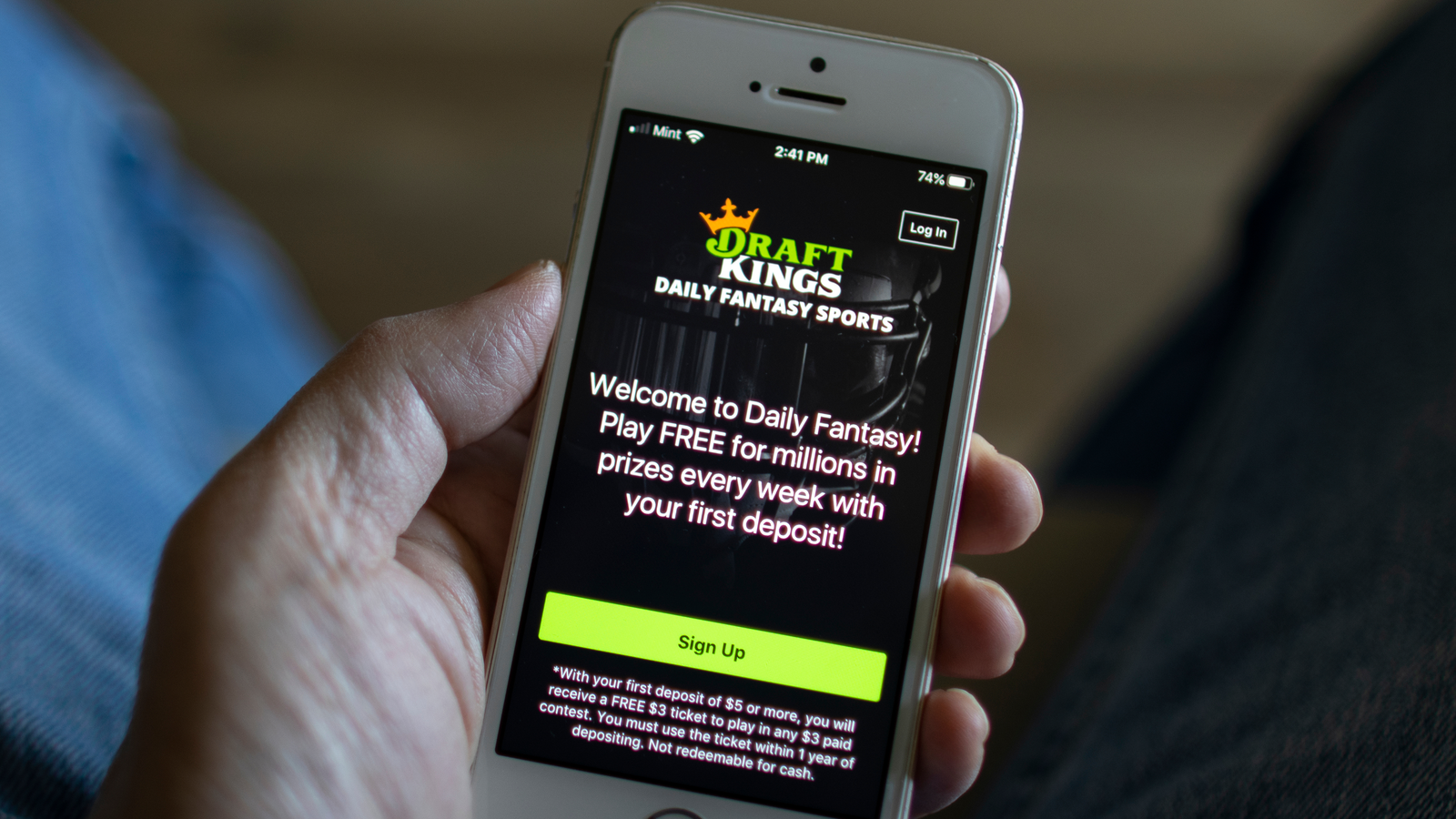 A man opens the DraftKings (DKNG) app from his iPhone. DraftKings is an American daily fantasy sports contest and sports betting operator.