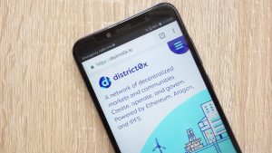 The District0x website displayed on a smartphone.