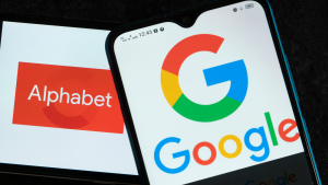 Alphabet Inc. logos  (GOOG, GOOGL) and Google are displayed on smartphones.  Google's stock split takes place today.