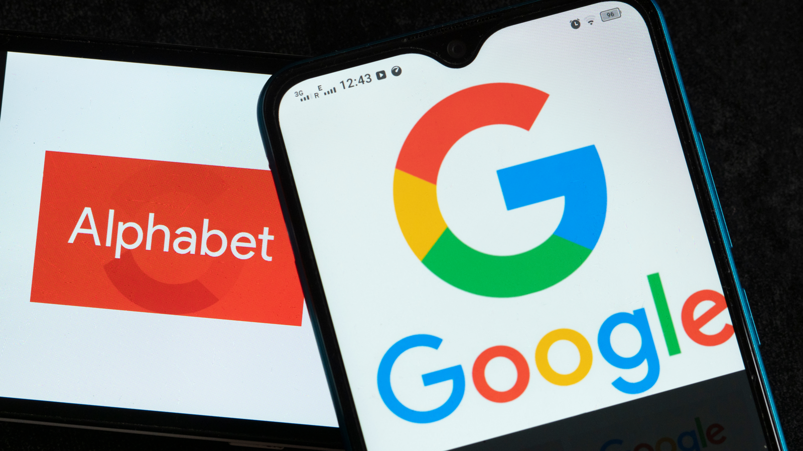 Alphabet Inc. (GOOG, GOOGL stock) and Google logos seen displayed on smartphones