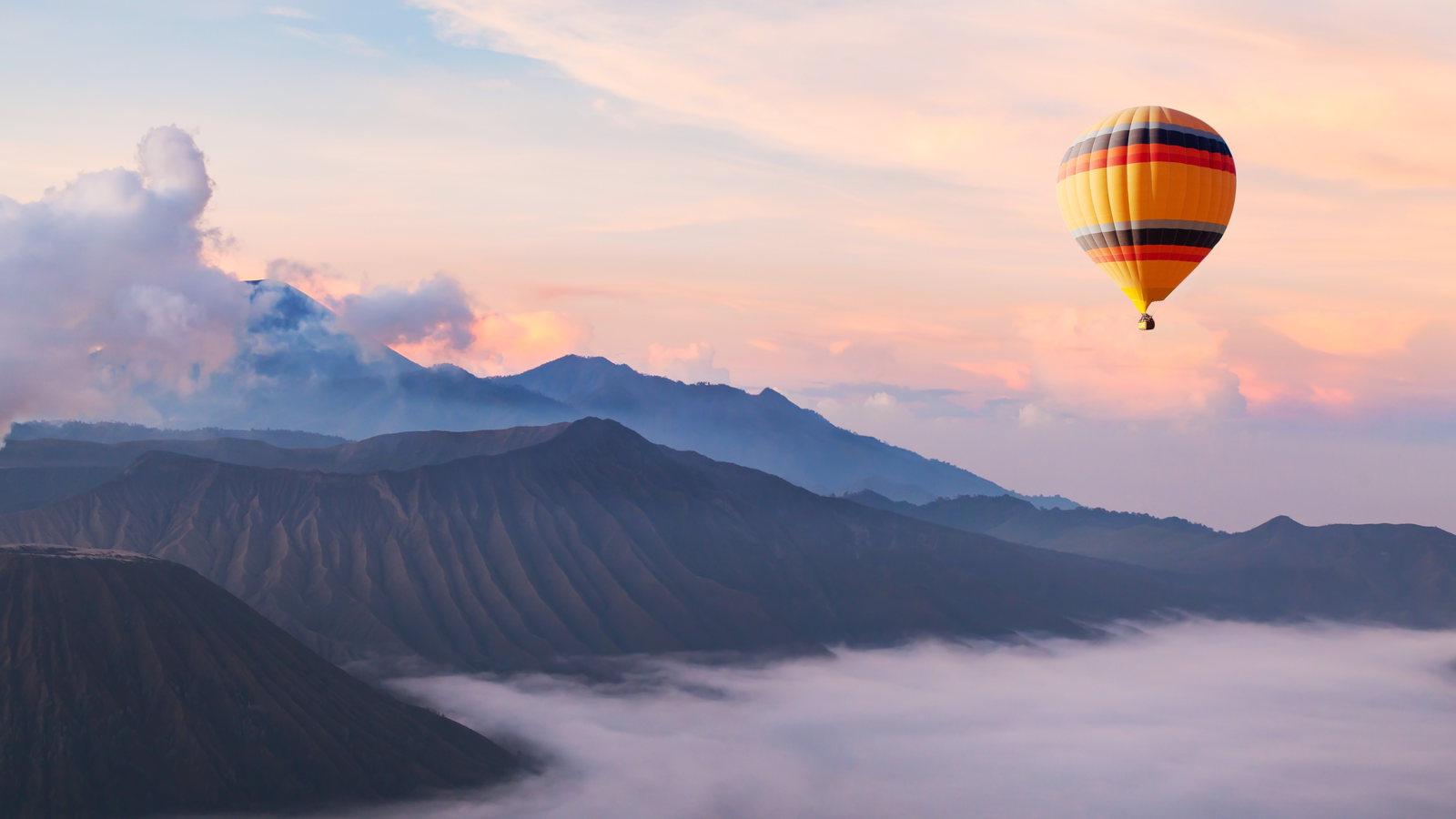 beautiful inspirational landscape with hot air balloon flying in the sky, travel destination, IPSO sells travel subscriptions
