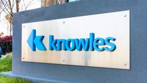 A photo of the Knowles logo on a sign.