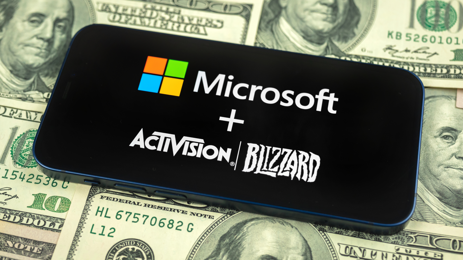 Microsoft and Activision Blizzard logo on smartphone screen close-up